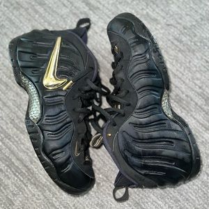 Black and metallic gold Nike air foamposite pro